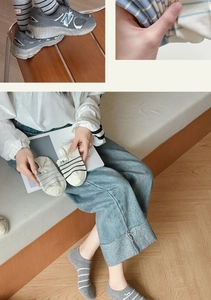 Detail showing high-quality cotton striped socks with small cartoon patterns in soft colors