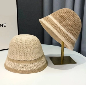 Women's woven straw bucket hat in beige and brown colors for sun protection