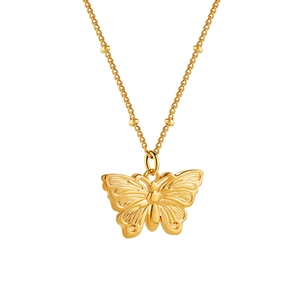 Detail of a 3D gold butterfly pendant on a satellite chain with small bead accents
