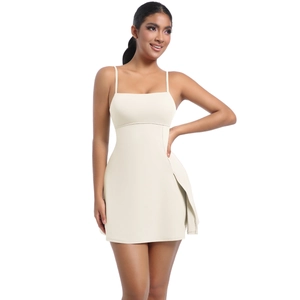 Detail view of cream white tennis dress featuring thin straps and side slit design