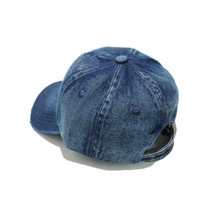 Side view of dark blue washed denim baseball cap with PARIS embroidery and back strap