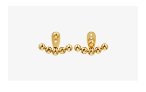 Detailed macro view of minimalist gold steel bead earrings with a mirror polished finish