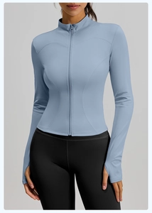 Detail view of the thumbhole cuffs and slim fit stitching on the blue yoga jacket