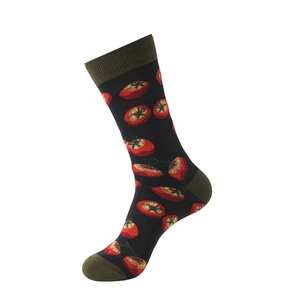 Close-up of black cotton crew socks featuring vibrant red tomato prints and green ribbing