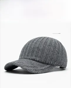 Detailed view of grey knitted baseball cap showing vertical ribbed texture and soft yarn
