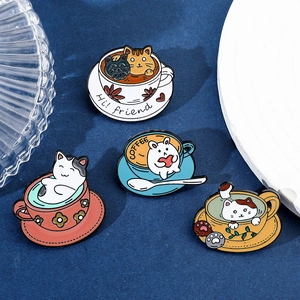 Detail shot of four cute cartoon cat and bunny enamel coffee cup pins on a blue background