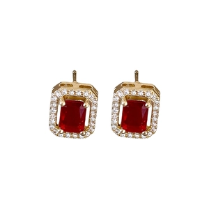 Sparkling gold square stud earrings with central ruby and diamond halo on white background