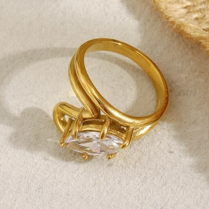 Minimalist double-layer 18K gold plated ring with marquise-cut zircon on cream background