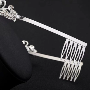 Detailed close-up of silver rhinestone crown with integrated side hair combs for secure fit