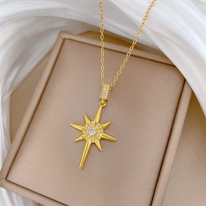 Elegant gold starburst necklace with sparkling crystals on premium silk and jewelry box