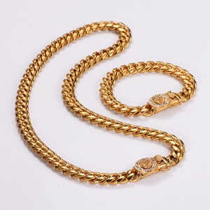 Detailed view of golden Cuban link necklace and bracelet set with lion head clasps