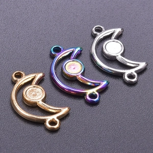 Macro shot of 18k gold, rainbow, and silver moon pendants with dual rings for DIY jewelry