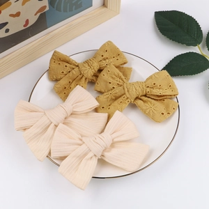 Set of 4 handmade children's embroidered and ribbed fabric bow hair clips for girls.