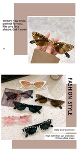 Detail view of cat-eye sunglasses with metal chain temple accents and diverse patterns