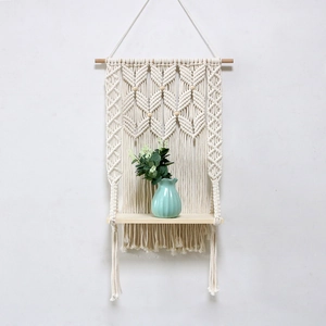 Handmade macrame wall hanging shelf with cotton rope and wood tray for home decor