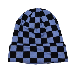 Detailed view of the blue and black checkerboard knit pattern and soft wool texture