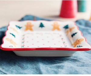 Detail of square ceramic plate with gingerbread man and Christmas tree patterns