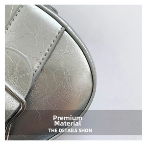 Close-up of shiny silver metallic textured PU leather with precise stitching details