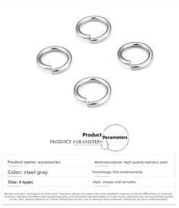 Detailed macro view of four steel-colored stainless steel open jump rings for DIY jewelry