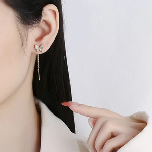 Elegant gold butterfly threader earrings with white zircon accents on a model