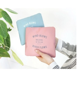 Folded portable travel organizer bag in blue and pink with artistic typography design