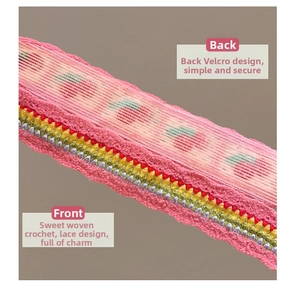 Detail of pink knitted floral headband with colorful crochet balls and velcro closure