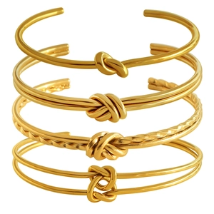Bracciali rigidi vintage francesi in acciaio al titanio placcati oro 18K con nodi