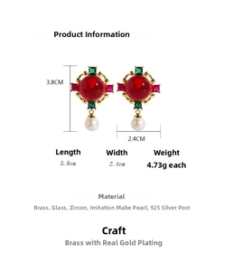 Macro detail of vintage brass earrings with emerald glass, pearls, and size measurements