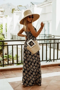 Detail of bohemian floral maxi dress with thin straps and airy fabric for summer beach vacation