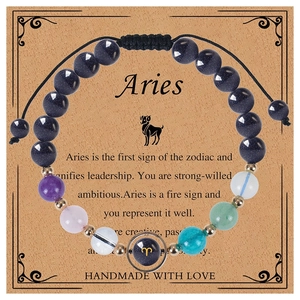 Detailed shot of Aries zodiac beaded bracelet on a vintage card with handmade description