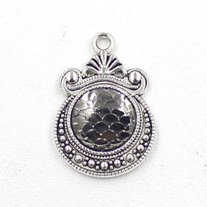 Macro view of a 12mm silver scale pendant with vintage bezel for DIY jewelry