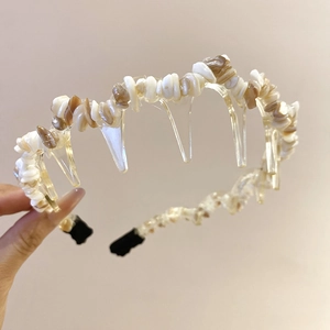 Detailed macro view of acrylic headband with faux white and beige crushed stones texture