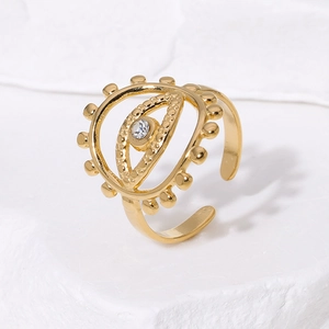 18K gold plated evil eye open ring featuring a sparkling central zircon on a stone surface