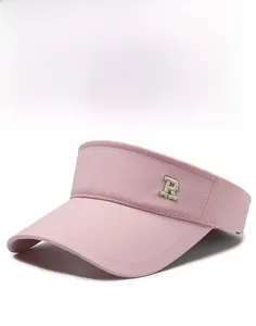 Detailed view of pink visor hat featuring a crisp brim and embroidered letter R on the side