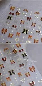 Gros plan de stickers à ongles nœuds en relief 3D avec dorure et motifs de papillons