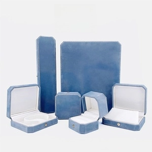Detailed macro view of light blue velvet jewelry boxes with octagonal white stitching
