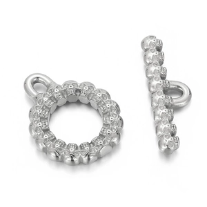 Macro detail of silver skull engraved toggle clasp and T-bar for jewelry making