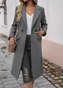 Close-up of a grey double-breasted wool coat with lapels for women in an autumn street setting