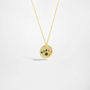 Gold evil eye pendant necklace with colorful cubic zirconia on a white background