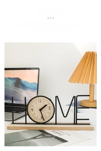 Macro detail of Nordic HOME wooden clock on a minimalist white office desk setup