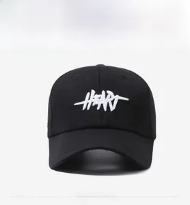 Front view of black baseball cap featuring white 3D Heart embroidery and curved brim