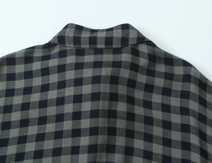 Close-up of the collar and back detail on a grey plaid gingham check shirt for women