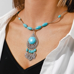 Bohemian heart turquoise necklace with silver hollow leaf pendants on a white shirt model