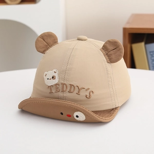 Close-up of baby sun hat featuring 3D teddy ears and TEDDY'S embroidery on soft fabric