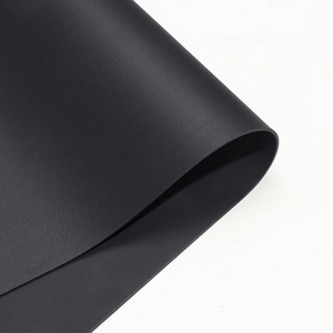 Macro shot of durable black leather fabric with fine lychee texture for DIY upholstery