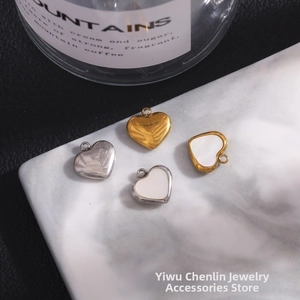 Macro view of 11mm stainless steel heart pendants with white shell inlay for DIY jewelry