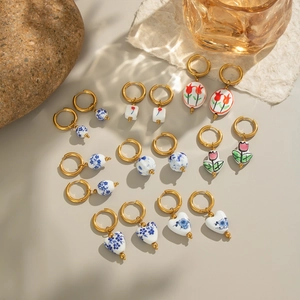 Collection of vintage enamel ceramic flower drop earrings with blue floral patterns
