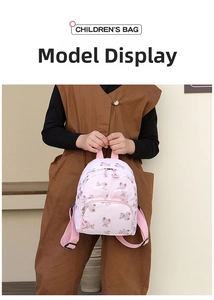 Pink children's backpack with cute bear patterns and front zipper pocket details