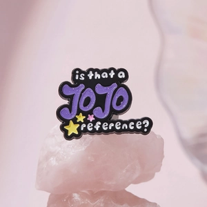 Cartoon enamel pin with 'is that a JOJO reference?' text and colorful stars decoration