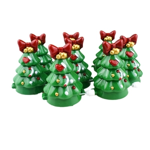 Set of six green clockwork walking Christmas tree toys with red bows and gold bells